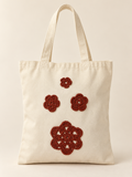 Bolsa con flores tejidas color óxido: vista principal (imagen ilustrativa creada con IA)